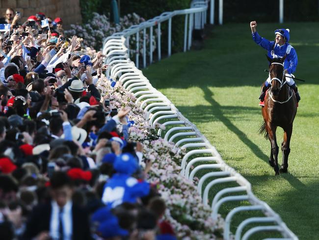 Walking into history: Hugh Bowman embarks on the victory parade with the star of the show. Picture: Getty Images