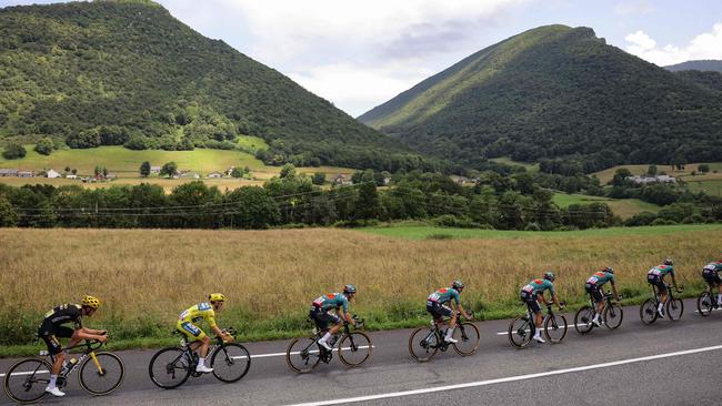 Australia’s Jai Hindley (second from left) wears the overall leader's yellow jersey during stage six of the Tour de France. Picture: AFP