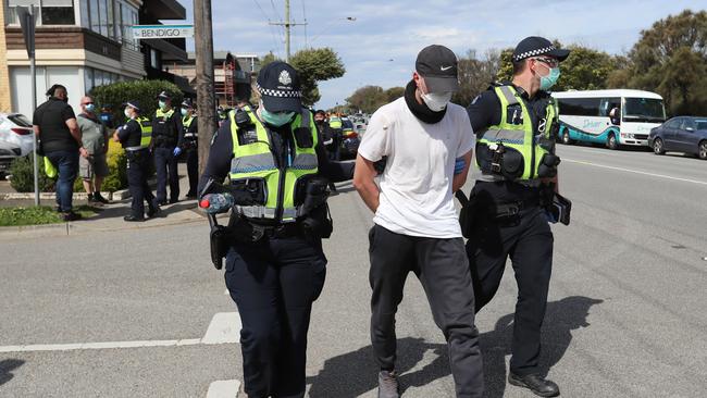 A man is taken away by police. Picture: Alex Coppel.