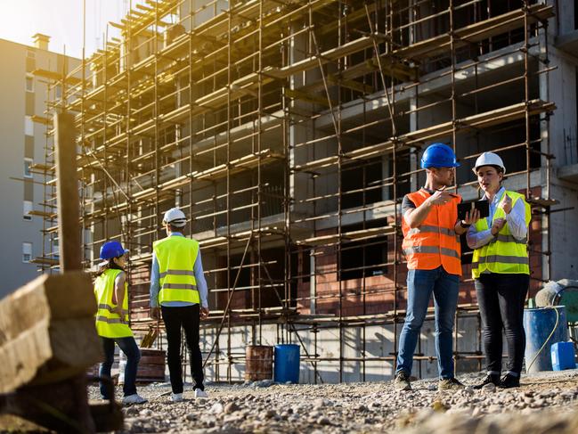 Four construction workers having meeting