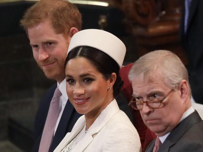 Meghan, Duchess of Sussex sits with Prince Harry, left, and Prince Andrew, right. Picture: AP