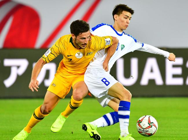 Australia's forward Mathew Leckie (L) vies for the ball with Uzbekistan's midfielder Ikram Alibaev during the 2019 Asian Cup. Picture: Giuseppe Cacace/AFP