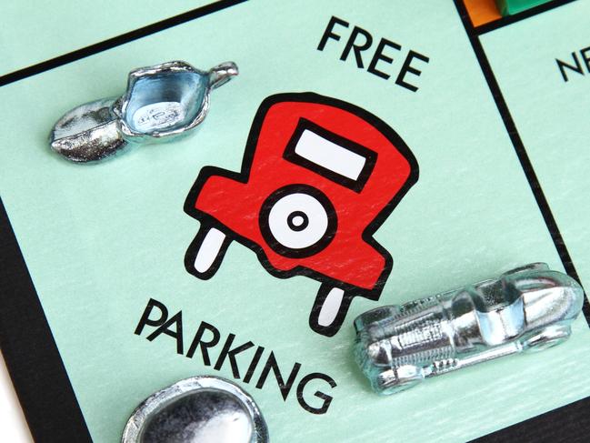 West Palm Beach, USA - July 25, 2011: This is an overhead closeup view of a Monopoly game board showing various playing pieces resting on the Free Parking square.  Monopoly is a popular board game that is owned and manufactured by Hasbro.