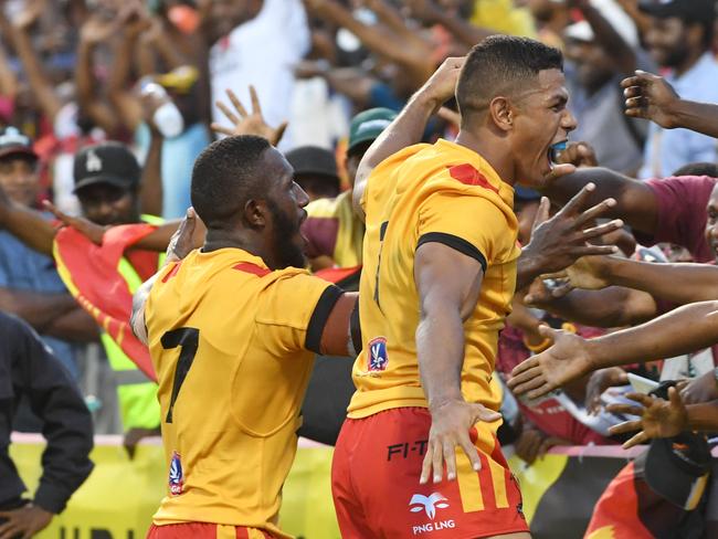 Papua New Guinea's Watson Boas (L) celebrates with captain David Mead after scoring the match-sealing try.