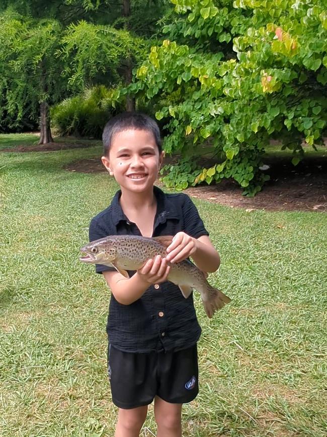 Henney, 7, at Mountain Fresh Trout and Salmon Farm Harrietville with his first catch of the day while on holiday with Nana and Poppy. Picture: Amanda Hinkley, Corowa.