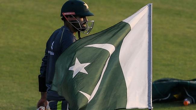 Pakistan's captain Babar Azam walks past the national flag at a practice session on the eve of the one-day international series against New Zealand in September before it was cancelled on the morning of the first match Picture: AFP