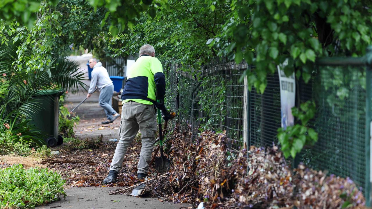 Residents cleanup the footpath on LeHunt Street. Picture: Russell Millard Photography