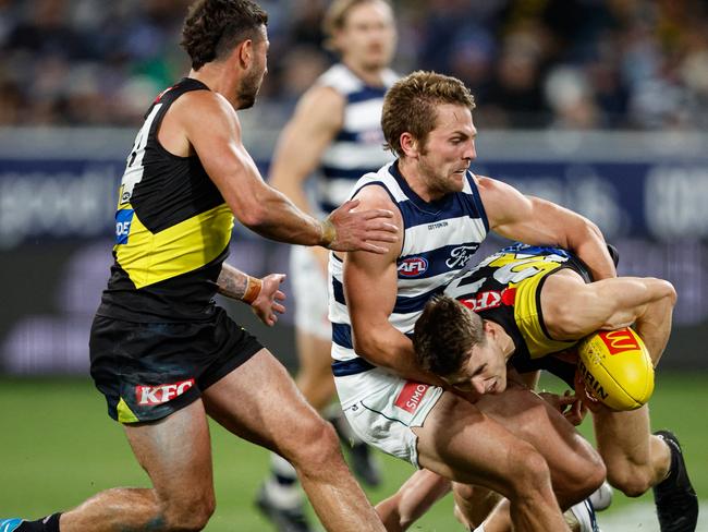 MELBOURNE, AUSTRALIA - JUNE 01: Thomson Dow of the Tigers is tackled by Tom Atkins of the Cats during the 2024 AFL Round 12 match between the Geelong Cats and the Richmond Tigers at GMHBA Stadium on June 01, 2024 in Melbourne, Australia. (Photo by Dylan Burns/AFL Photos via Getty Images)