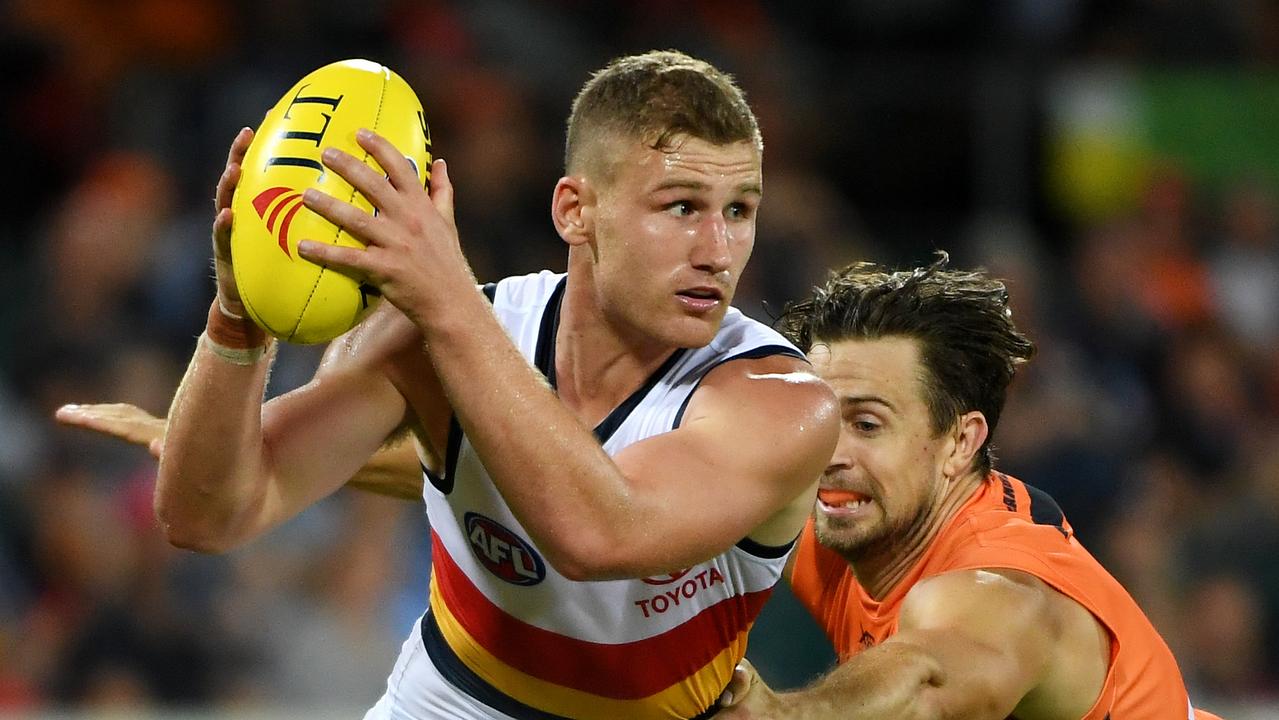 Crows Rory Laird  is tackled by GWS Giants Brett Deledio at UNSW Canberra Oval in Canberra. Picture: Tracey Nearmy/Getty