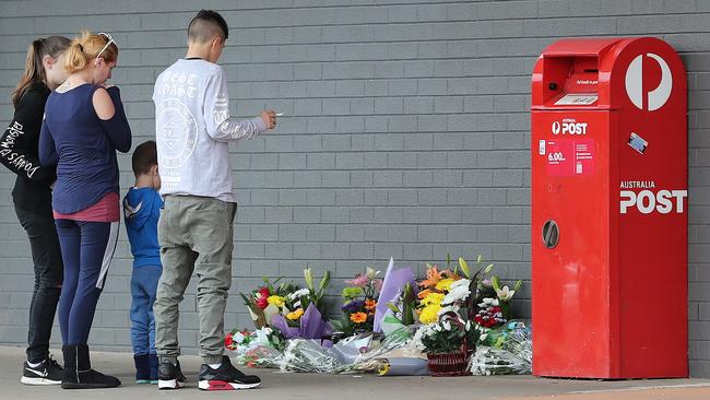 Mourners at the floral tribute to Alexander Watts left outside Elizabeth shopping centre.