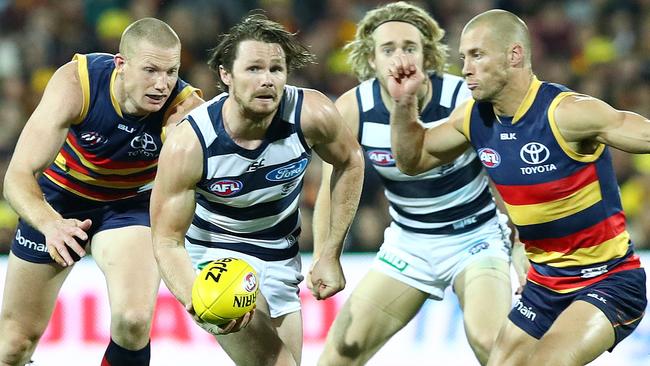 AFL - Adelaide Crows v Geelong at Adelaide Oval. Patrick Dangerfield brings the ball out from Sam Jacobs and Scott Thompson. Picture Sarah Reed