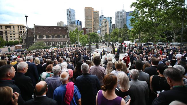 Mourners gather around the hearse outside the cathedral. Picture: David Caird