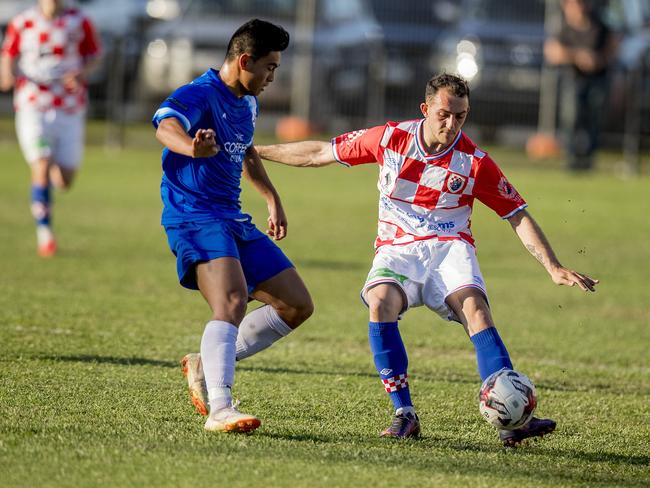 Surfers Paradise’s Julian Matthews and Gold Coast Knights' Nicholas Panetta do battle in the Gold Coast Premier League preliminary final at Carrara. Picture: Jerad Williams