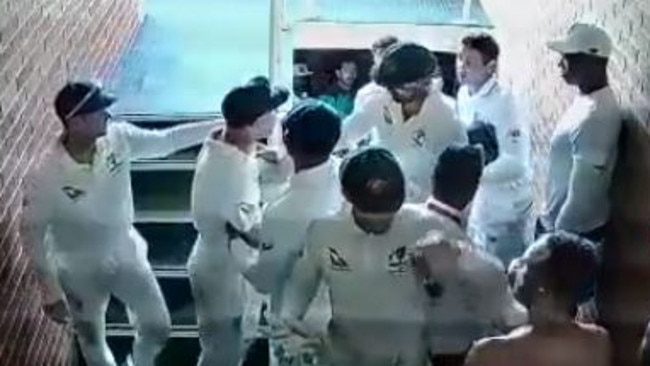 David Warner is restrained by teammates after an altercation in the run with Quinton de Kock.