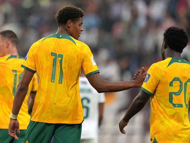 Kusini Yengi (left) is congratulated by Nestory Irankunda after scoring Australia’s second goal against Bangladesh. Picture: Thananuwat Srirasant/Getty Images