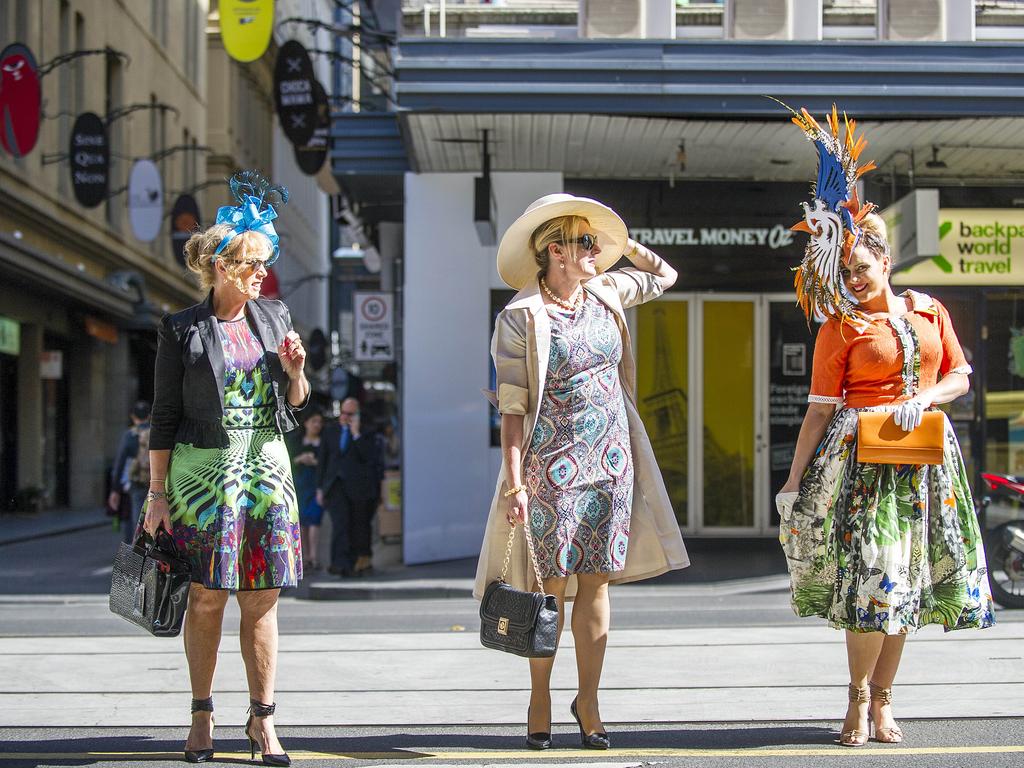 (L-R) Pam Meale, Karen Cacciotti and Cassandra Ambrose crossing Flinders Street on their way to the races. Picture: Eugene Hyland