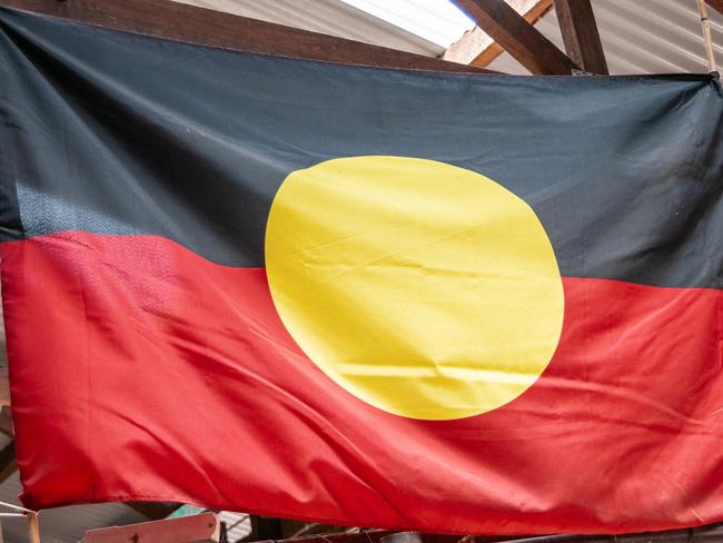 Port Douglas, Queensland, Australia - December 4, 2009: Closeup of black, red and yellow pride flag of aboriginals displayed.