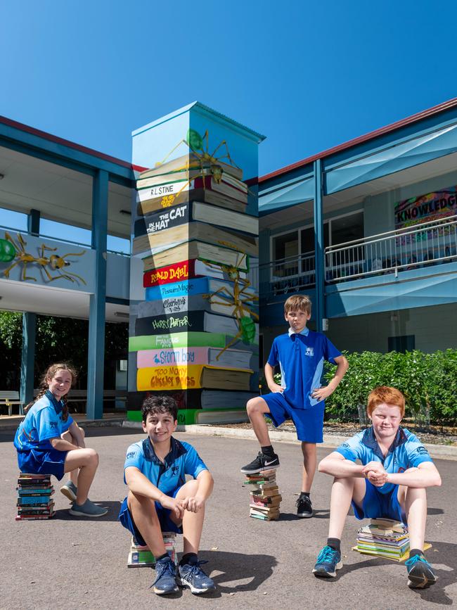 Chloe Warthold, Peter Diamandopoulos, Oscar Collins and Ralph Stephens in front of the mural book stack. Picture: Che Chorley