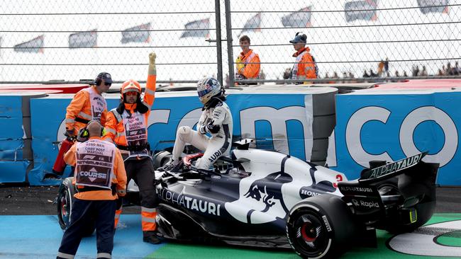 Daniel Ricciardo of Australia and Scuderia AlphaTauri climbs from his car after crashing during practice. (Photo by Lars Baron/Getty Images)