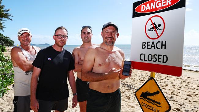 Trinity Beach was closed on Saturday morning when a small saltwater croc was seen swimming cose to shore in the stinger net enclosure. Sydney tourists Emmanuel Ciappara, Nathan Galvin, Jessy Ciappara and David Chetcuti stand beside a Danger - Beach Closed sign after spotting the crocodile and taking some photos on their phone. Picture: Brendan Radke