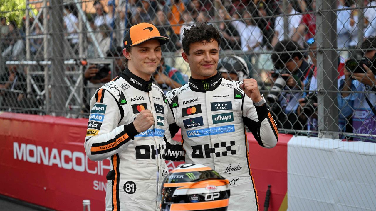 McLaren's British driver Lando Norris (R) celebrates after winning the Formula One Monaco Grand Prix with second-placed McLaren's Australian driver Oscar Piastri (L) at the Circuit de Monaco, on May 25, 2025. (Photo by Christophe Simon / AFP)