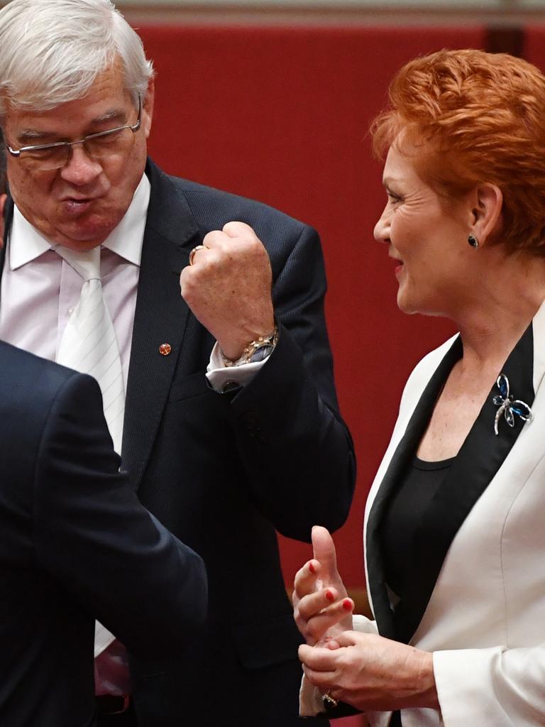 Ms Hanson looks on as Mr Burston gives Senator Peter Georgiou a fist pump after his maiden speech in Canberra in 2017. Picture: AAP/Mick Tsikas