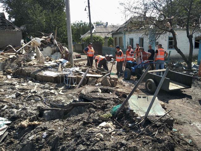 Communal workers clear debris of a destroyed house after the recent Russian air strike in the town of Chaplyne, Dnipropetrovsk region. Picture: AFP