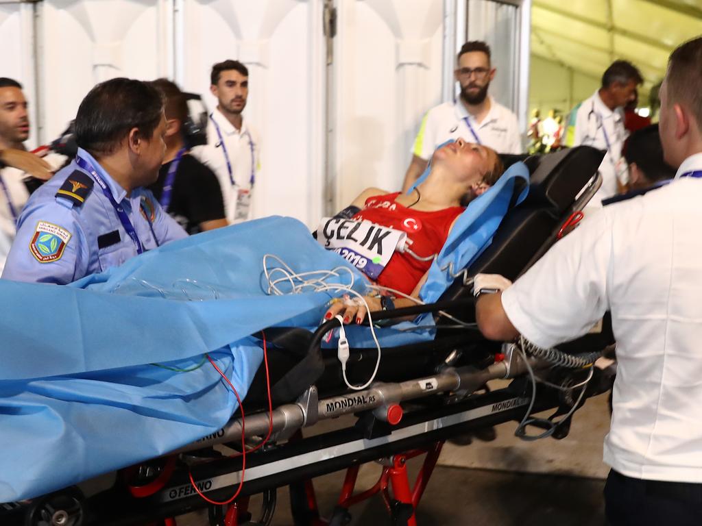 A runner from Turkey is taken off on a gurney during the Women's Marathon.