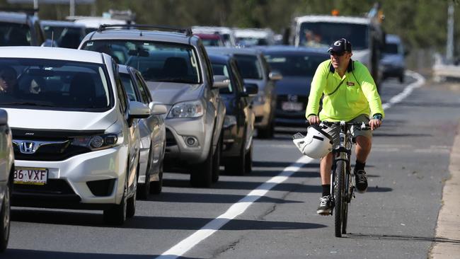 A cyclist during peak time traffic along Bermuda Street, Gold Coast. Picture: Regi Varghese