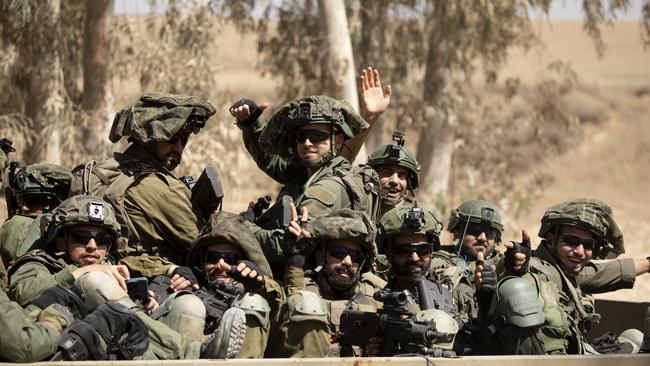 Israeli soldiers ride in an army vehicle along the border with the Gaza Strip on Monday. Picture: Amir Levy/Getty Images