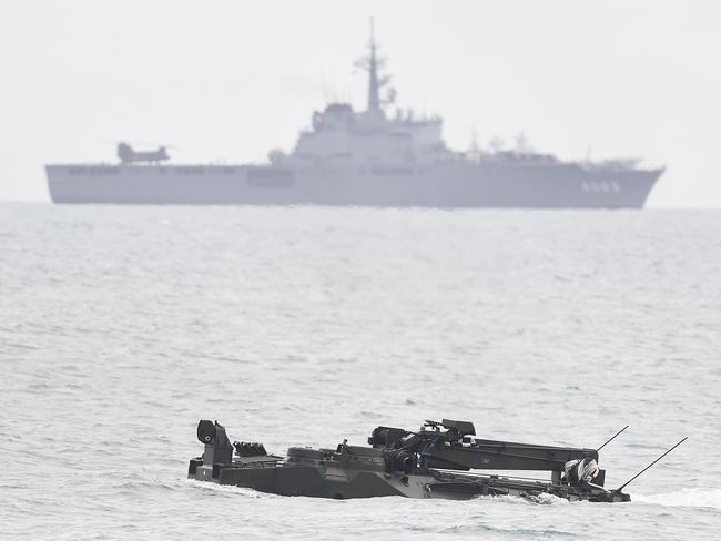 Japanese navy ship JS Kunisaki sits off shore as a Japanese Assault Amphibious Vehicle comes ashore in a beach landing in Bowen as part of Exercise Talisman Sabre 2019. Picture: Ian Hitchcock/Getty Images