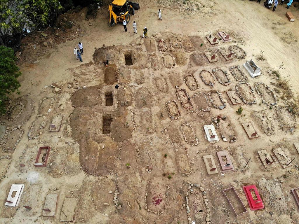 Burying the dead bodies of coronavirus victims at a graveyard in New Delhi. Picture: AFP