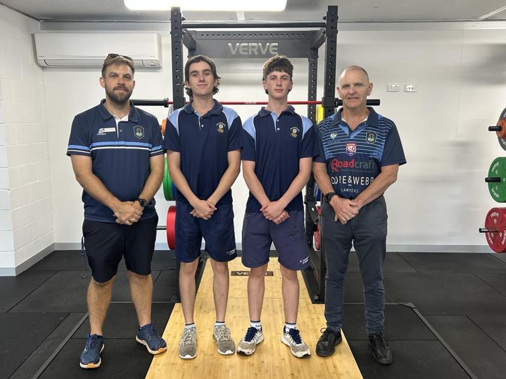 PE leader of learning Todd Pooley, students Flynn Nolan and Ayden Mitchell, and principal Mark Newton at the gym.