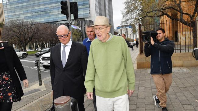 Brian William Ross, in green, leaves court with his brother, in blue, and lawyer Michael Woods. Picture: AAP/David Mariuz.