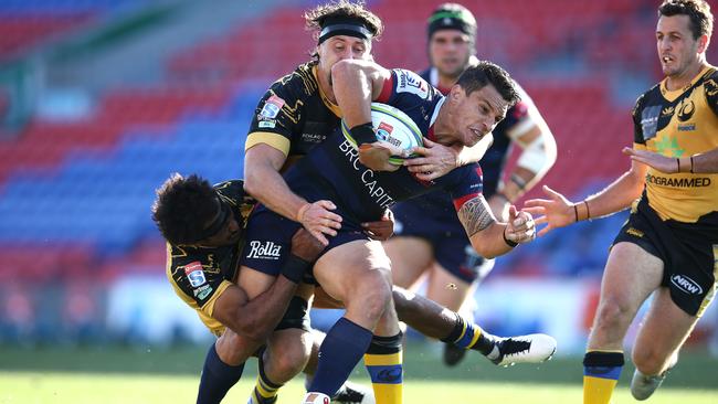 Matt Toomua of the Melbourne Rebels is tackled during the round 10 Super Rugby match against Western Force at McDonald Jones Stadium on Saturday. Picture: Getty Images