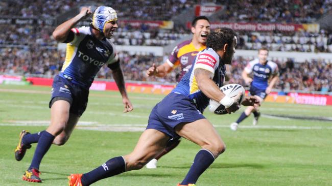 Johnathan Thurston celebrates as Matt Bowen runs in to score a try for the Cowboys.