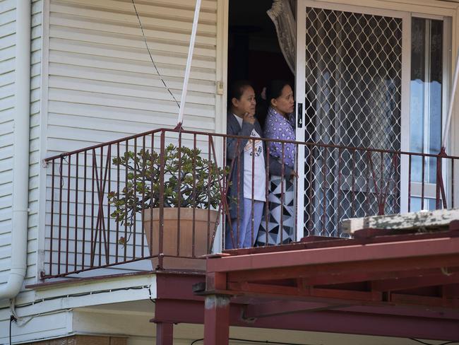 Neighbours watching firefighters and police on the scene. Picture: Attila Csaszar