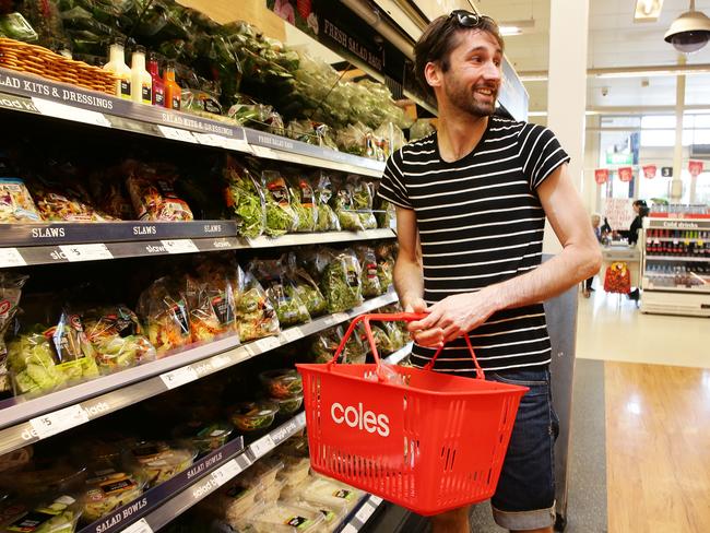 This customer at Coles in Brisbane looks tempted away from the produce. Picture: Claudia Baxter/AAP