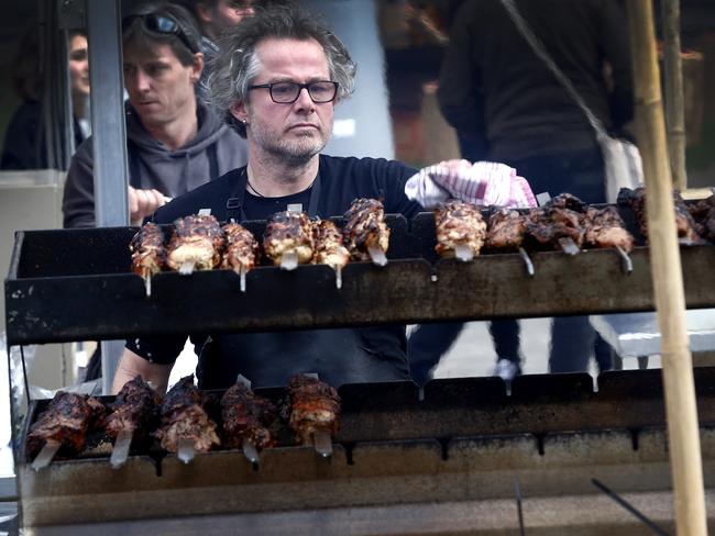 Vince Trin cooking lamb and pork skewers.