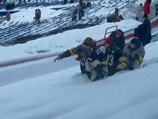 A family of Steelers fans fights their way to a seat.