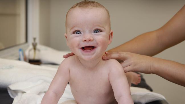 Baby Fabian enjoys an infant massage after his hydrotherapy bath. Picture: David Caird