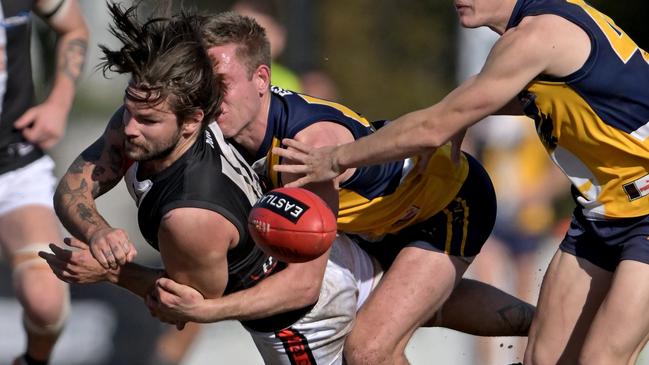 EFNL: North Ringwood’s Jack Whelan is caught by Damien Johnston of Beaconsfield. Picture: Andy Brownbill