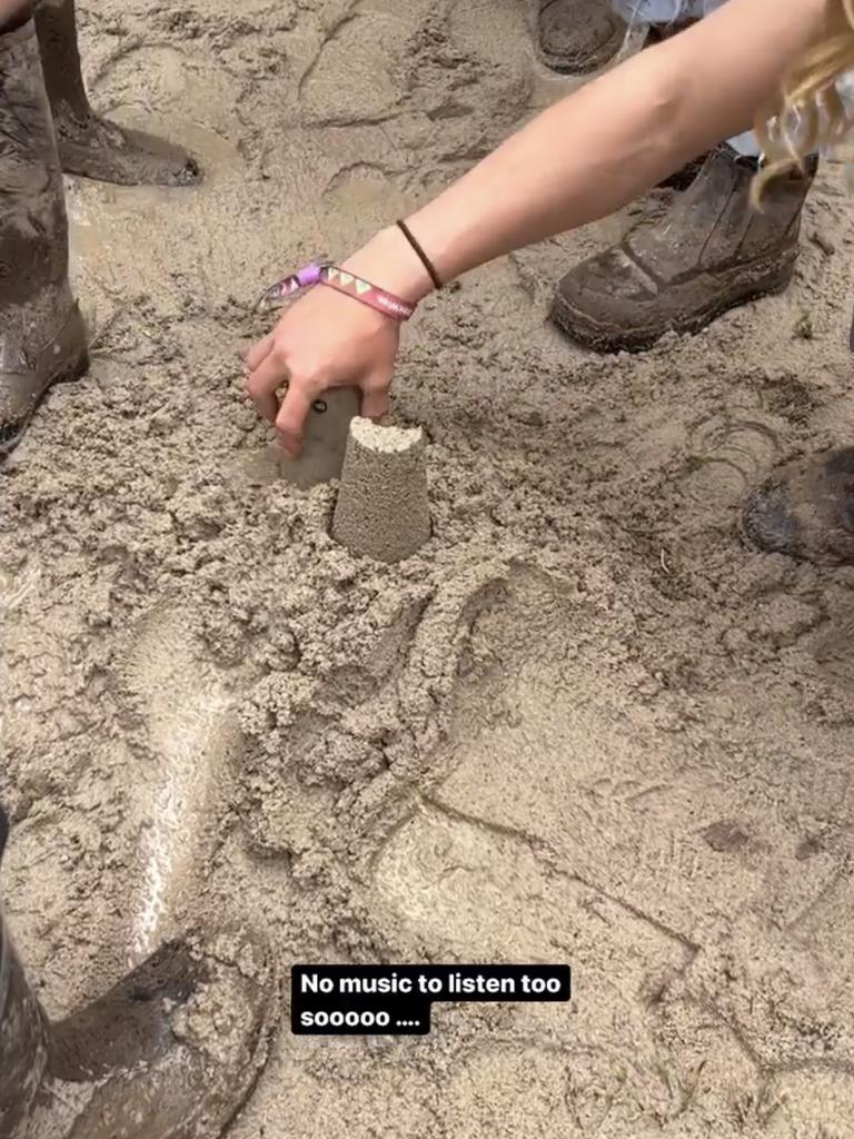 Splendour in the Grass festival attendees have started to make sand castles in the mud after hearing the news that all music acts had been cancelled for Friday. Picture: Tash Nichols