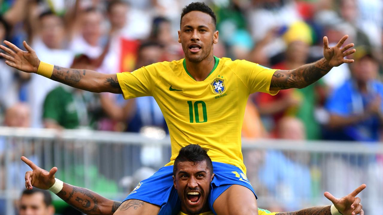 Neymar Jr of Brazil celebrates with teammate Paulinho.