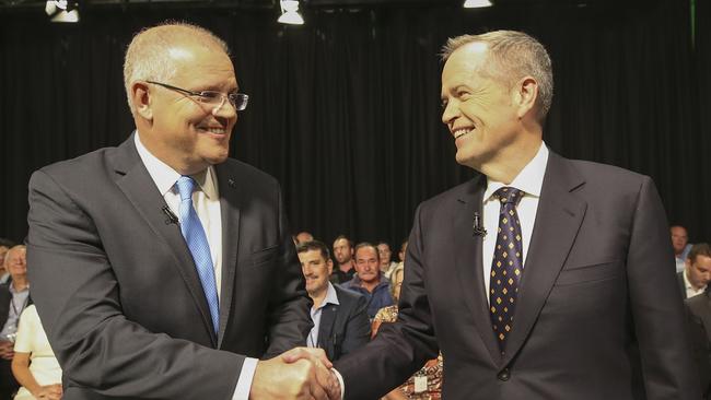 Australia's Prime Minister Scott Morrison (L) and opposition leader Bill Shorten shake hands before the first televised leaders debate in Perth on April 29, 2019. - The two men vying to lead Australia for the next three years faced off over the economy and plummeting trust in politicians in a testy first televised debate on April 19. (Photo by NIC ELLIS / POOL / AFP)