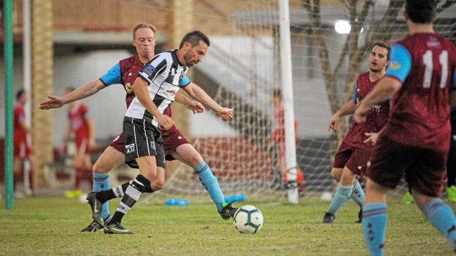 Bingeras Joshua Watson tries to find space around Ryan Miller to take a shot at the goal. Picture: Brian Cassidy