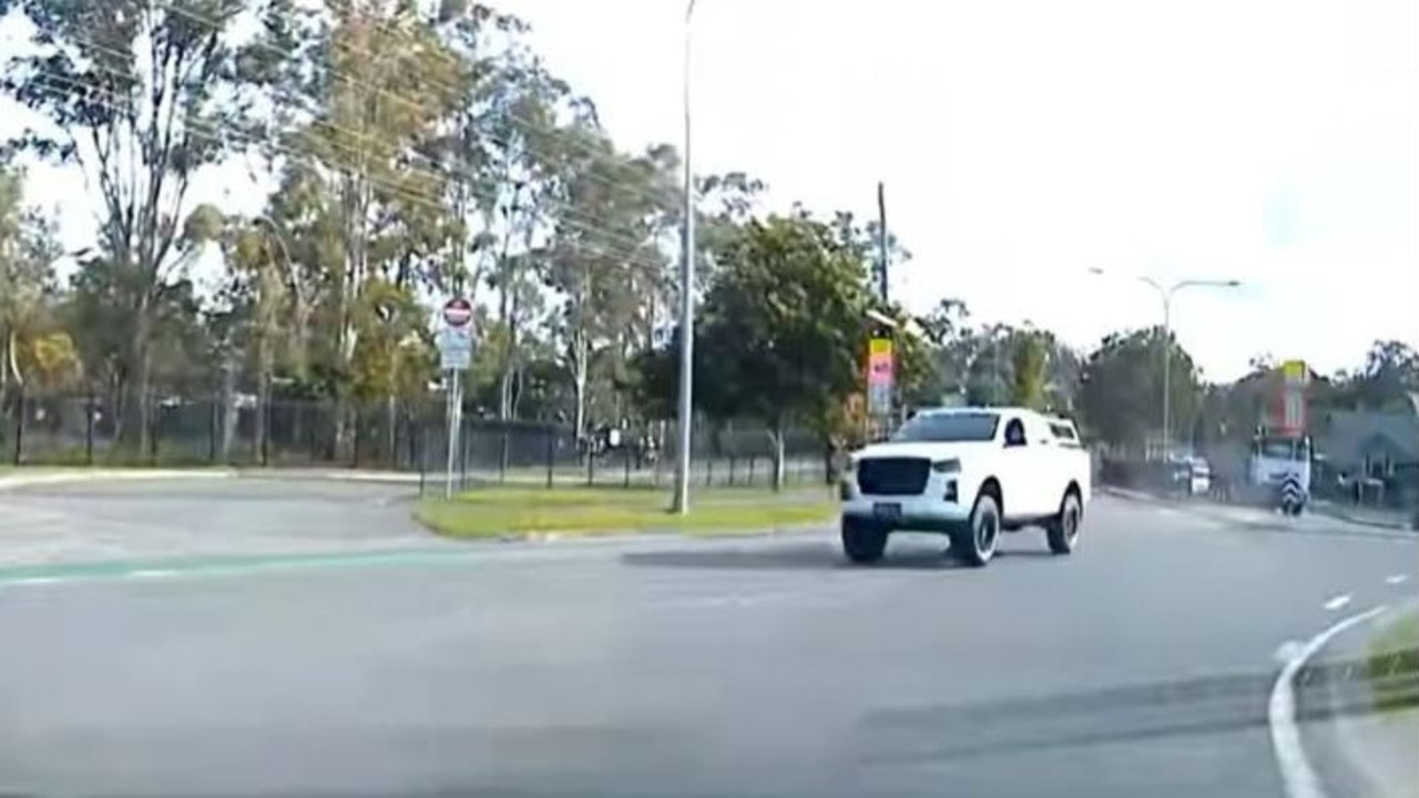 A ute pictured driving on the wrong side of the road outside Helensvale State High School. Picture: Monterey Keys Community Group / Facebook.