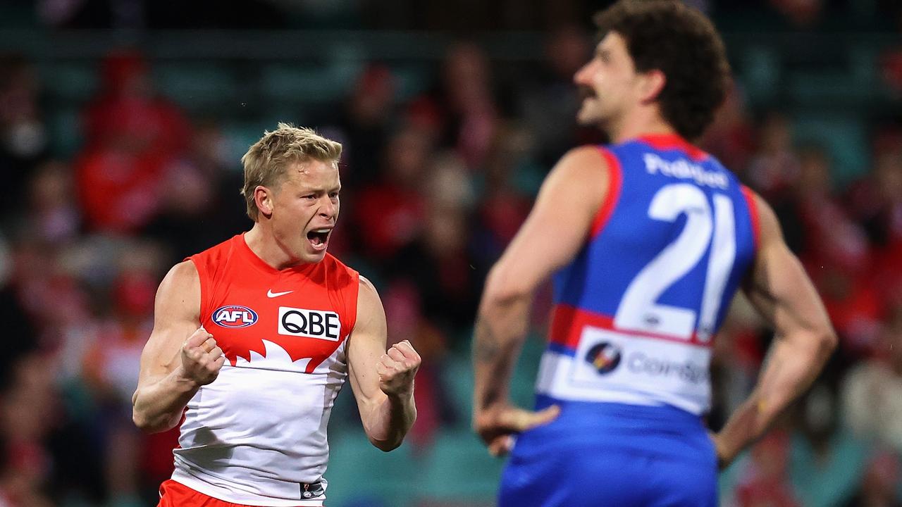 The ecstasy and the agony, Isaac Heeney celebrates in front of a frustrated Tom Liberatore. Picture: Getty Images