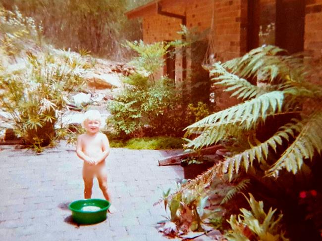 Shanelle Dawson as a child at the Bayview home that her mother Lyn Dawson disappeared. She is standing on the 'soft soil' area where some people believe a body could be buried.