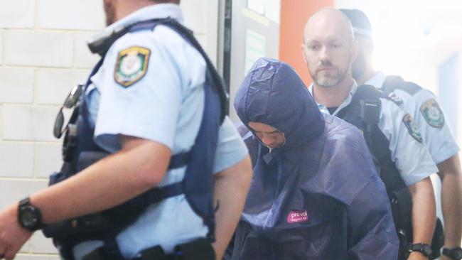 Tyron Knodler was transported by police still in a blue forensic suit. Picture John Grainger